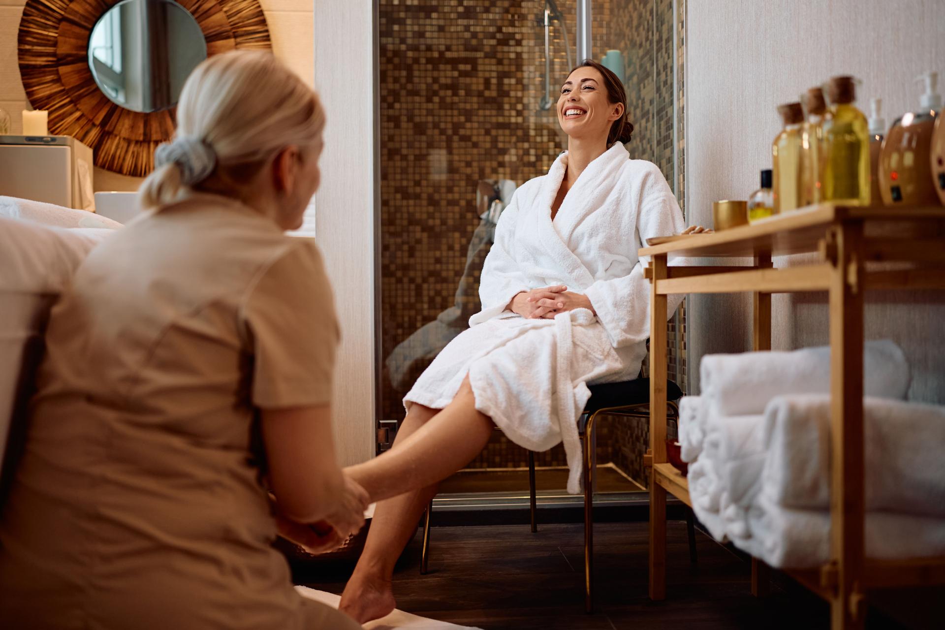 Happy woman enjoying a foot massage at the spa.